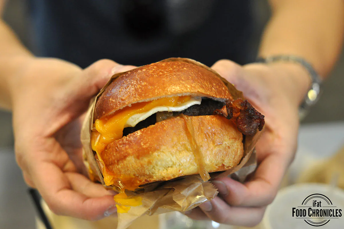 Eggslut cheeseburger with ground american wagyu beef, caramelized onions, bread and butter pickles, melty cheddar cheese, and dijonnaise, topped with an over medium egg in a warm brioche bun (I added bacon too because bacon)