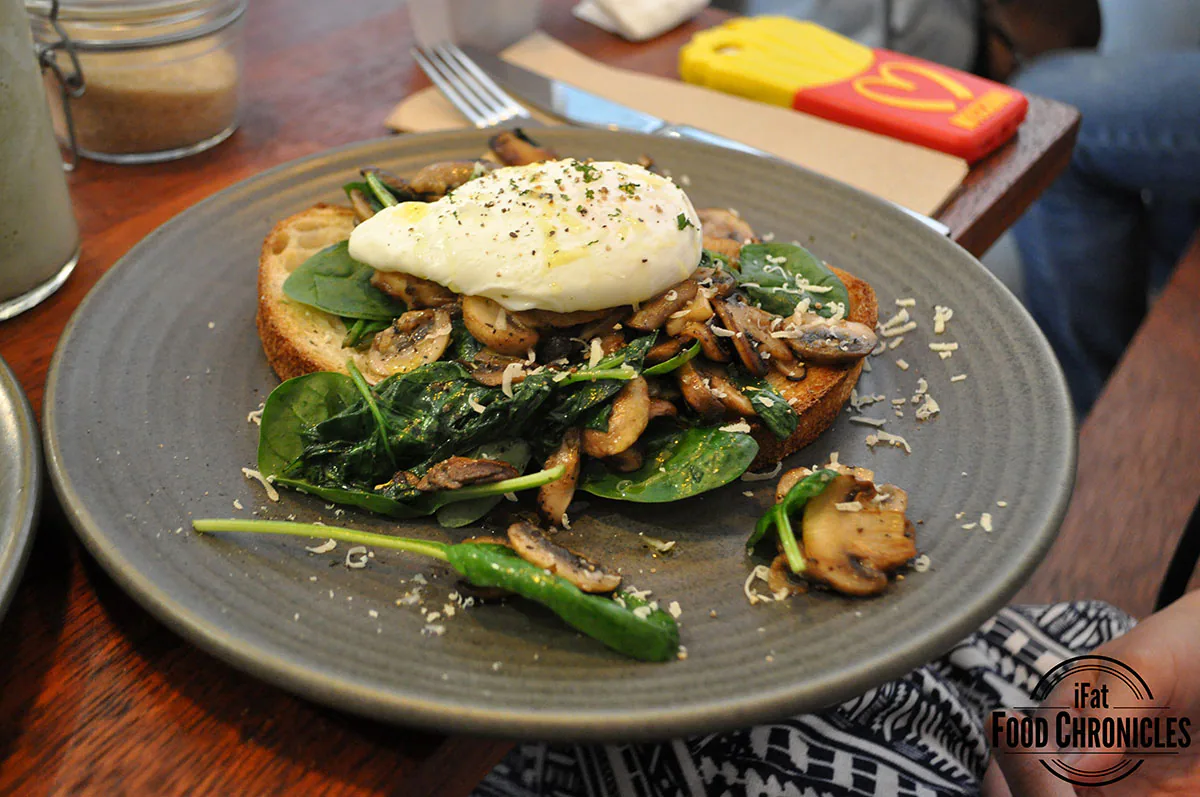 Wild Mushroom Bruschetta with sauteed mushooms on organic sourdough, topped with a poached egg and parmesan cheese.