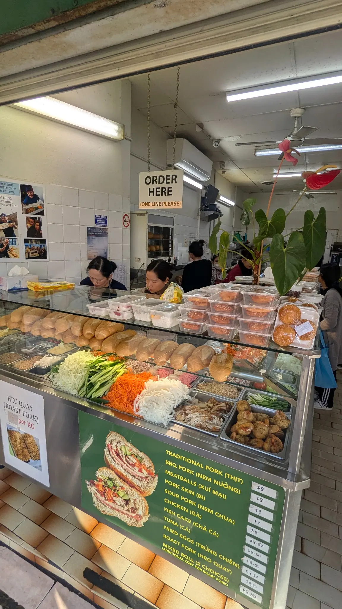 Banh Mi Bay Ngo counter displaying bread, meats and fresh banh mi fillings in Bankstown