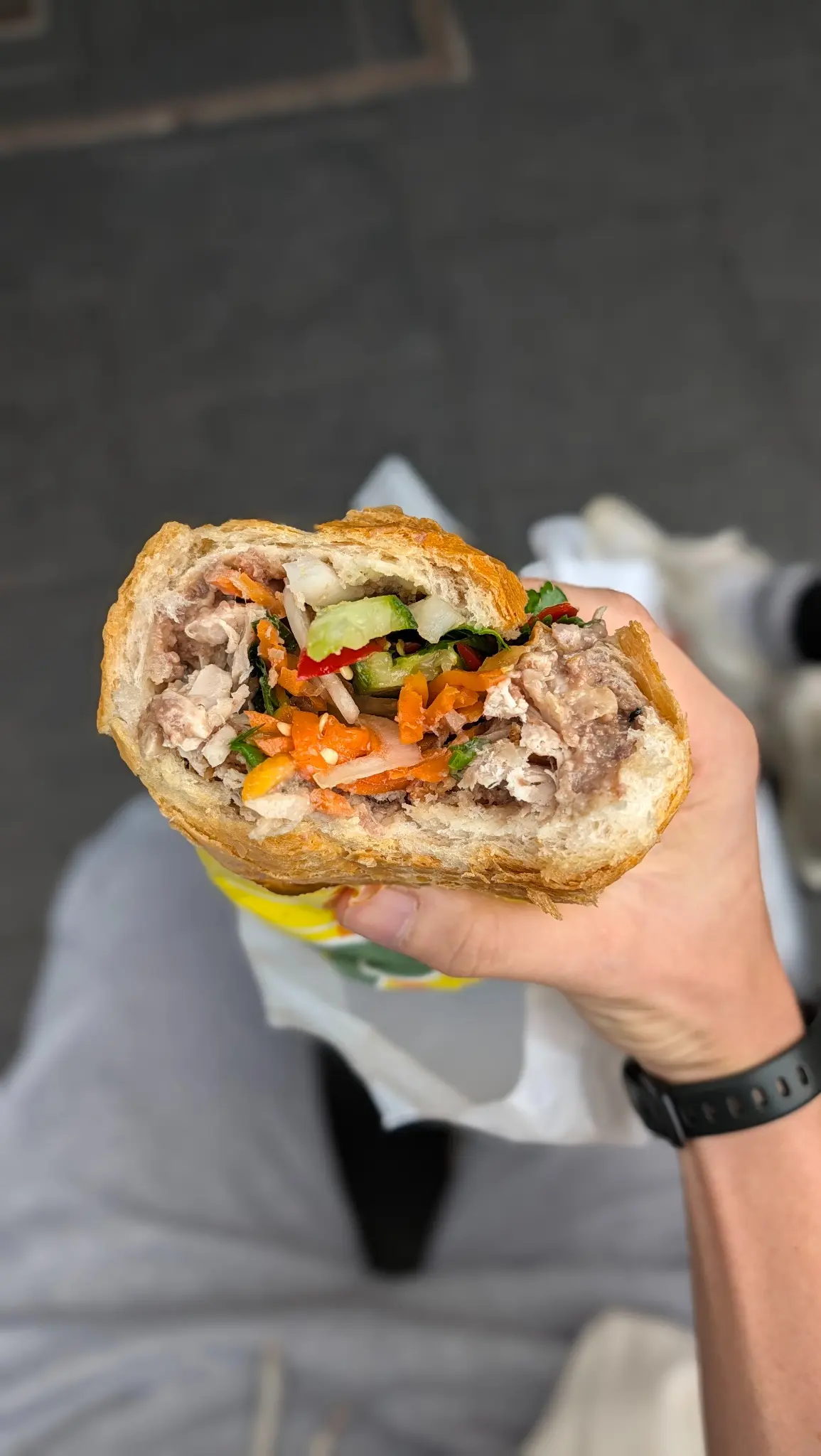 Cross-section of Banh Mi Bay Ngo chicken banh mi showing chicken, pate, cucumber and pickled vegetables