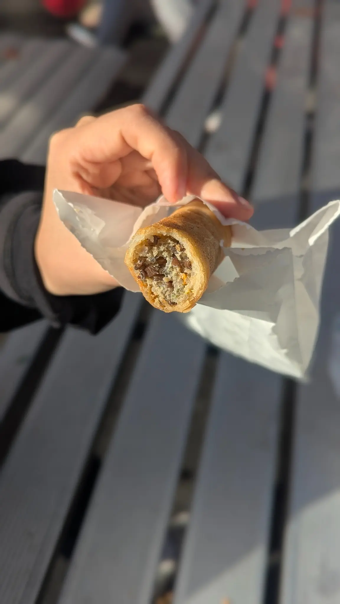 Cross-section of a crisp Banh Mi Bay Ngo spring roll showing its savoury filling