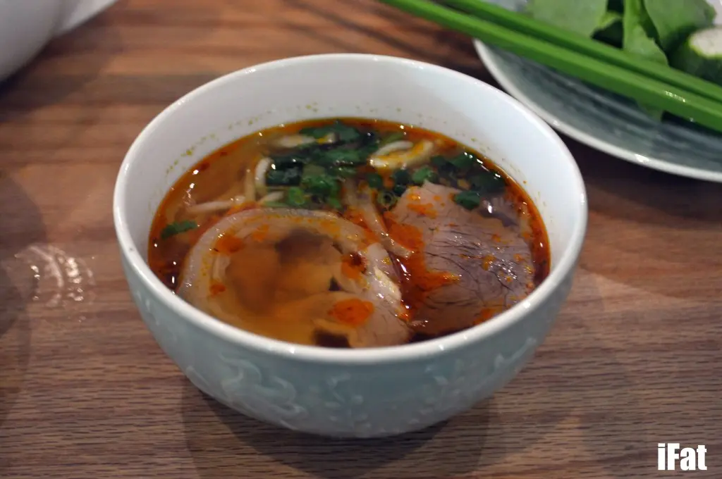 Bun bo hue and cha la: Spicy pork and beef soup served with mini cold pork parcels in banana leaves.