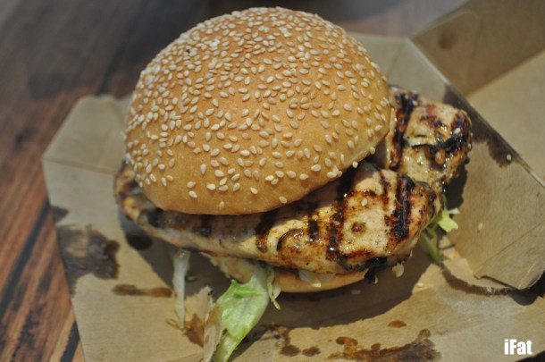 Lemon & herb chicken burger with lettuce, Spanish onion, tomato and aioli