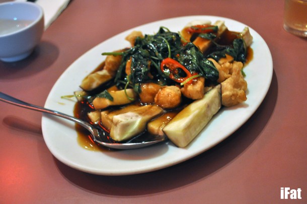 Steamed eggplant with crunchy nuggets and basil.
